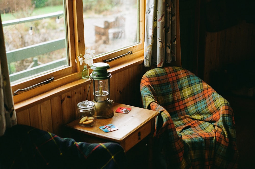 a person sitting at a table in front of a window