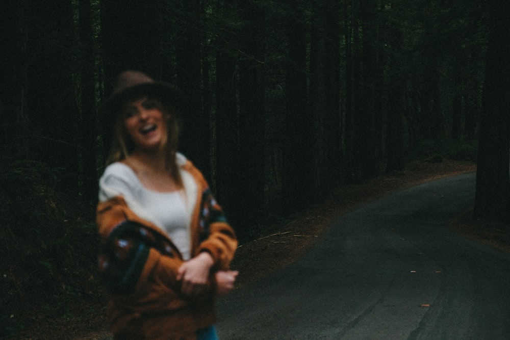 a woman standing in the middle of a road