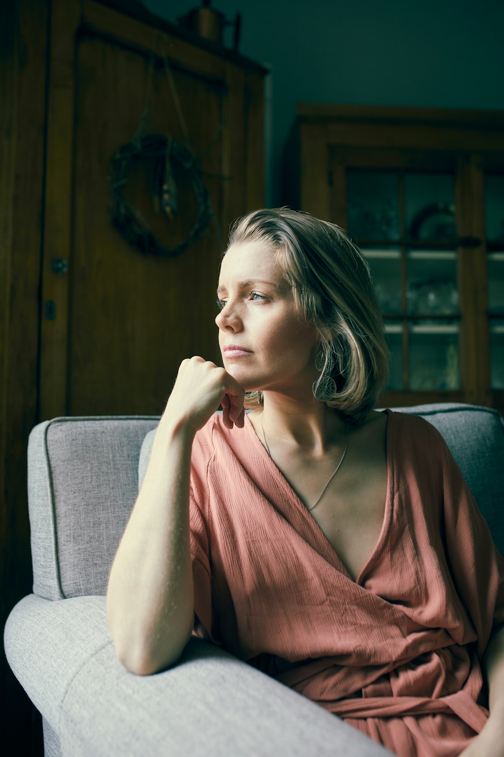 a woman sitting on a couch in a room