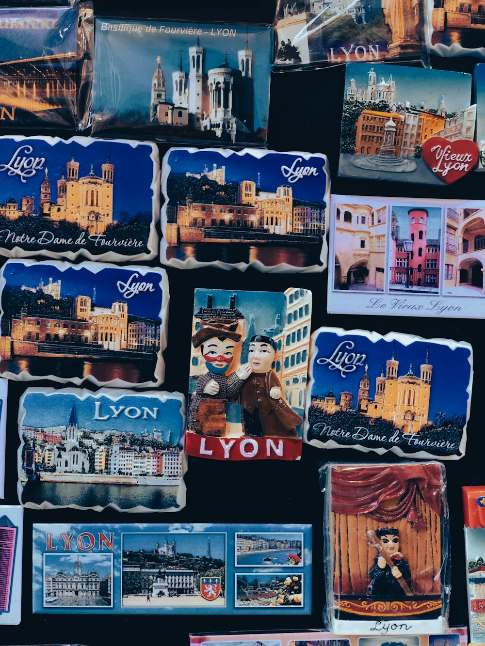 a wall covered in postcards and pictures of buildings