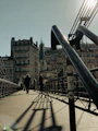 a group of people walking across a bridge