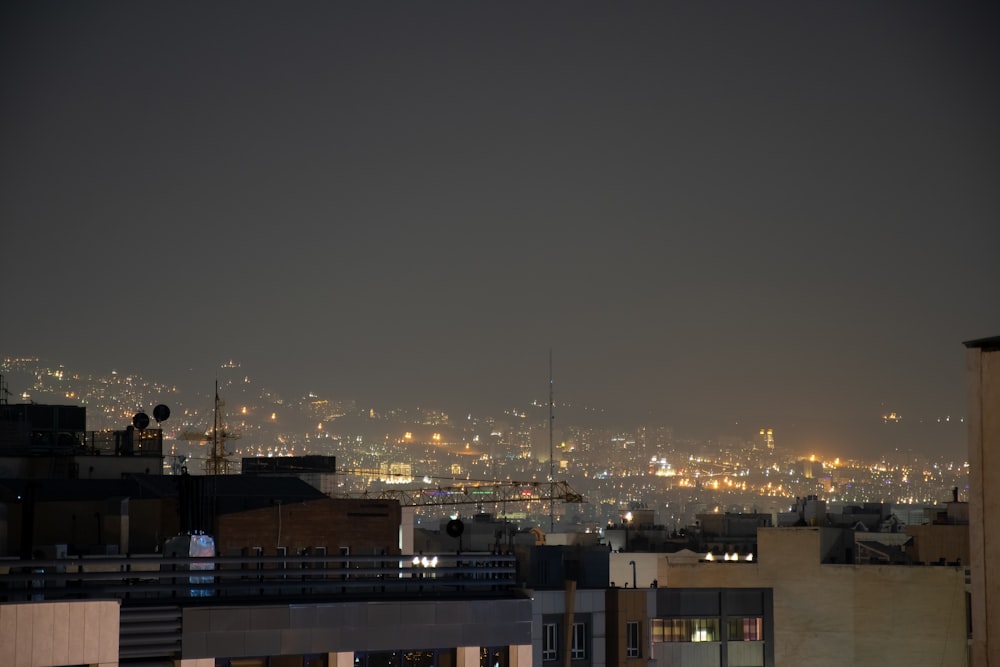 a view of a city at night from a rooftop