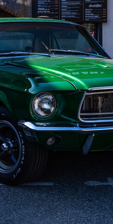 a green mustang parked in a parking lot