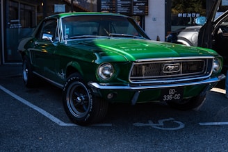 a green mustang parked in a parking lot