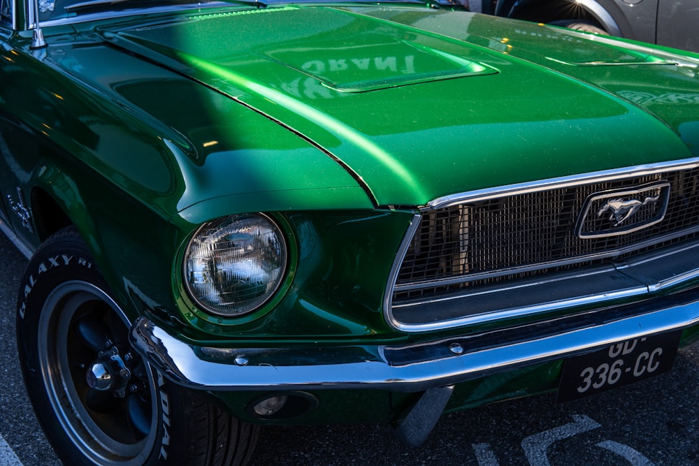a green mustang car parked in a parking lot