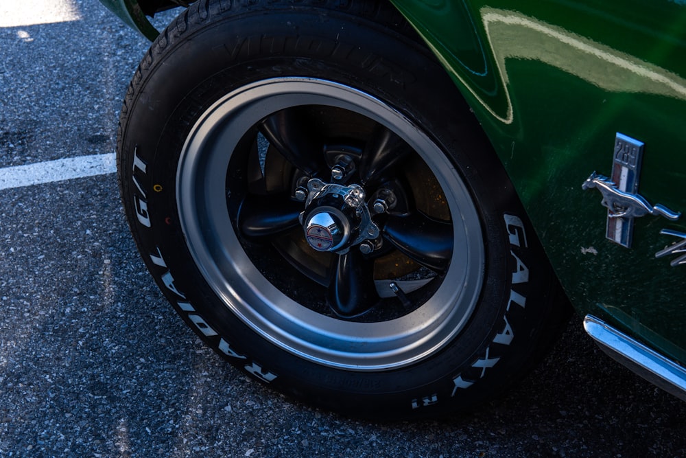 a close up of a tire on a green car