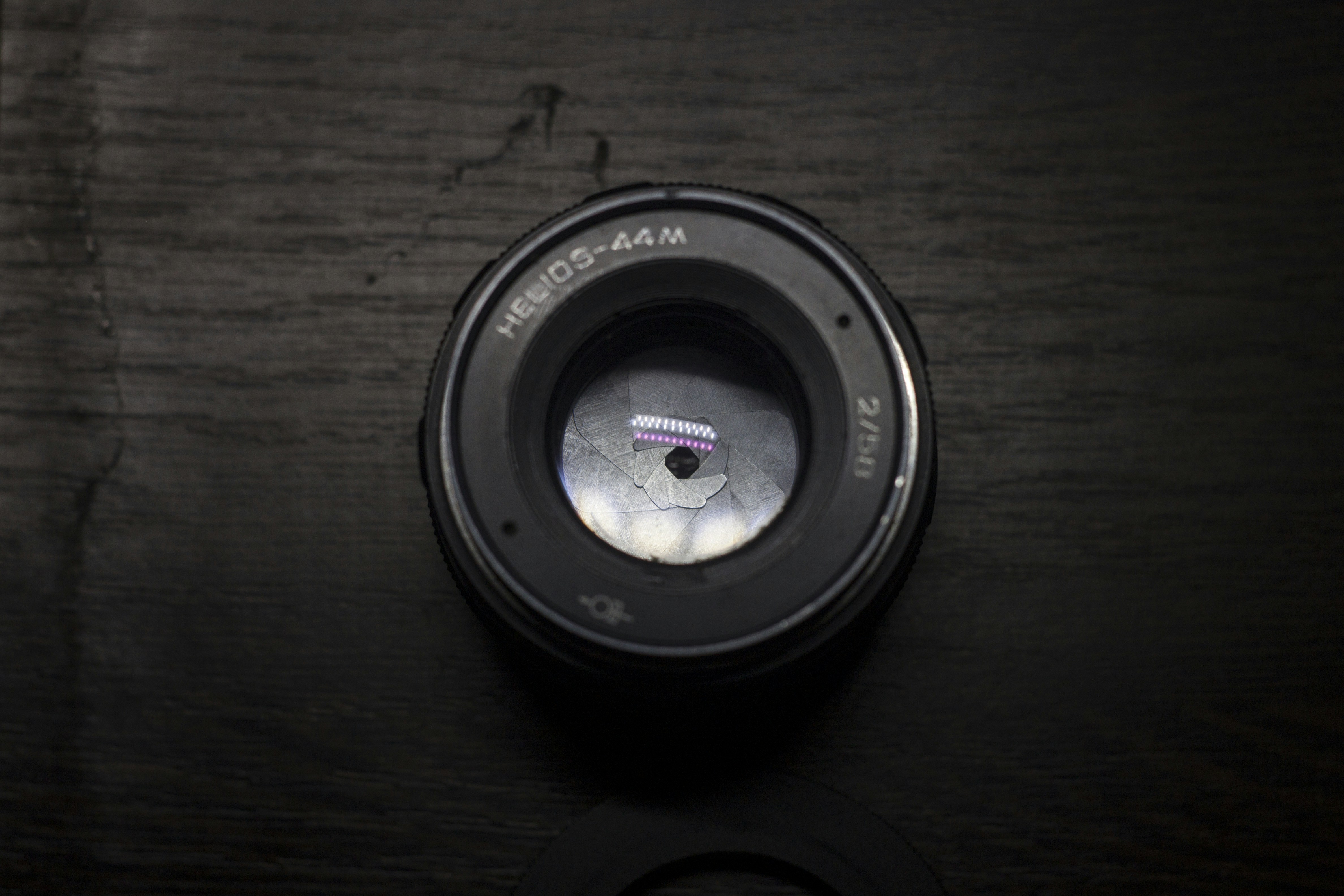 a camera lens sitting on top of a wooden table