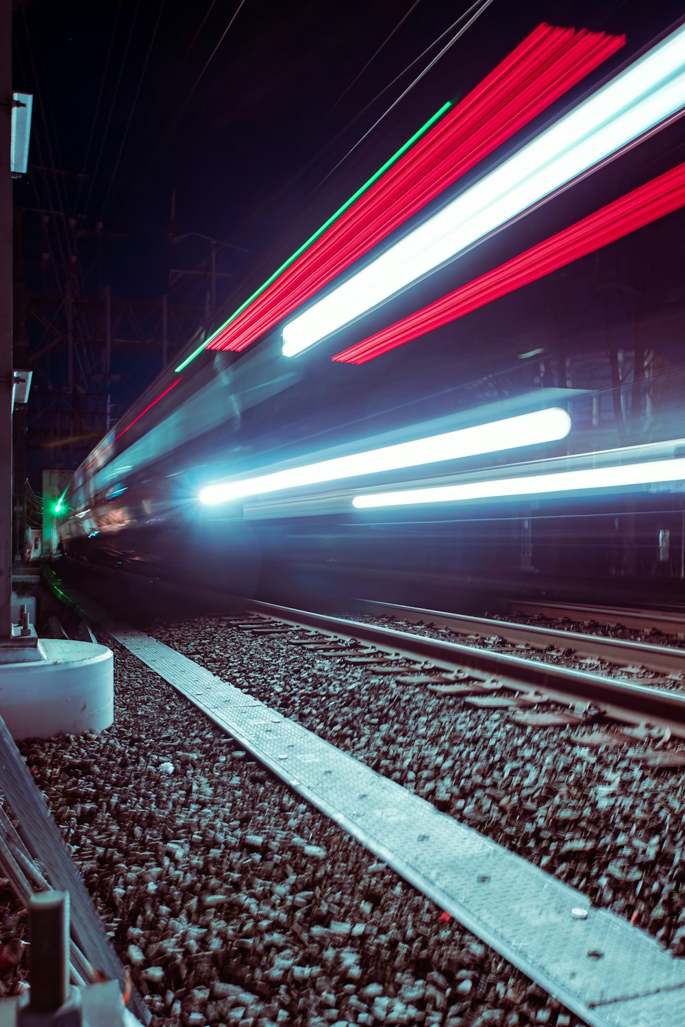 a train traveling down train tracks at night