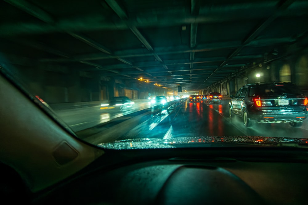 a view of a city street at night from inside a car