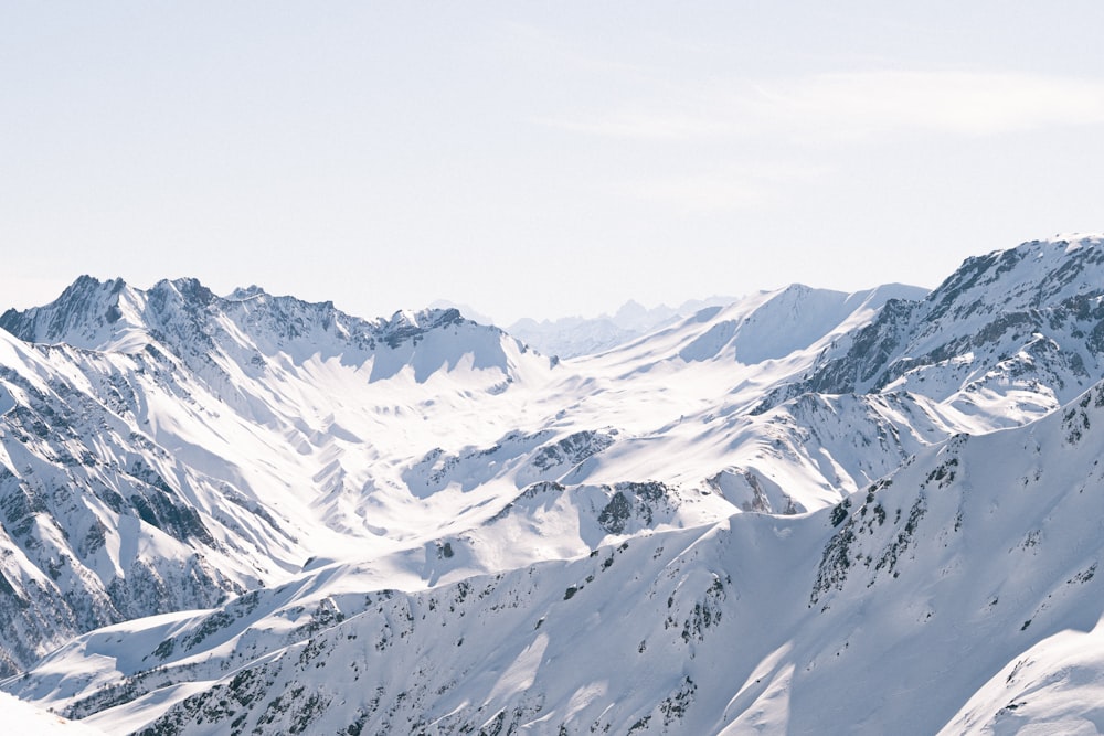 a man riding skis down the side of a snow covered mountain