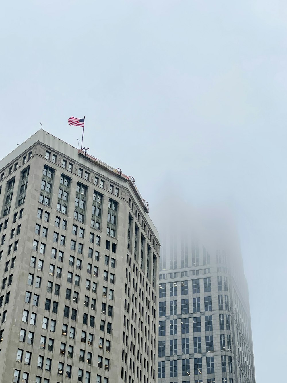 a very tall building with a flag on top of it