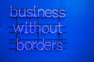 a neon sign that says business without borders