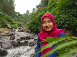 a woman standing in front of a river
