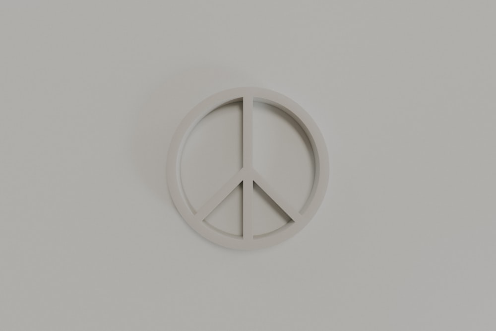 a peace sign on a white wall