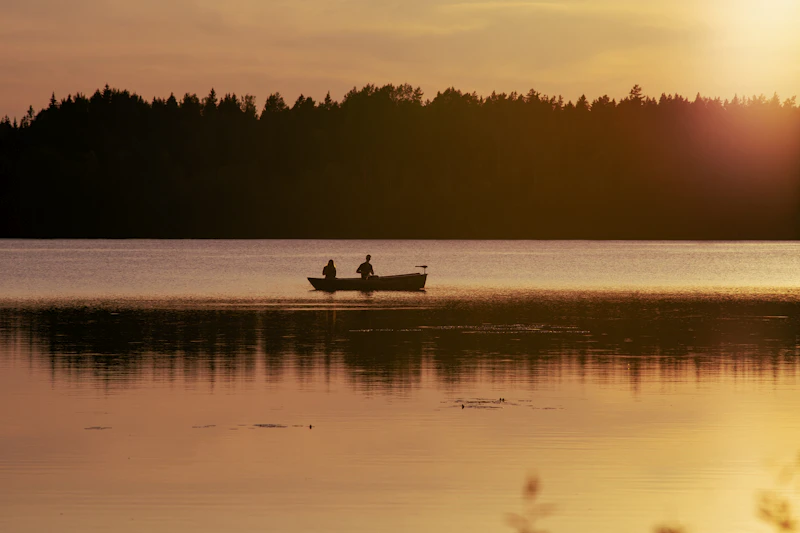 Two people in a small boat on a lake