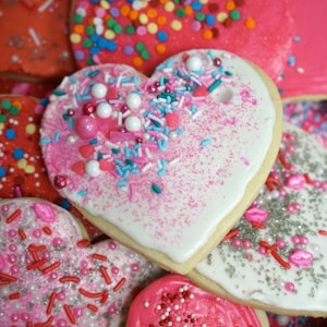 Pink, white, and red decorated heart-shaped cookies for Valentine&#39;s Day.