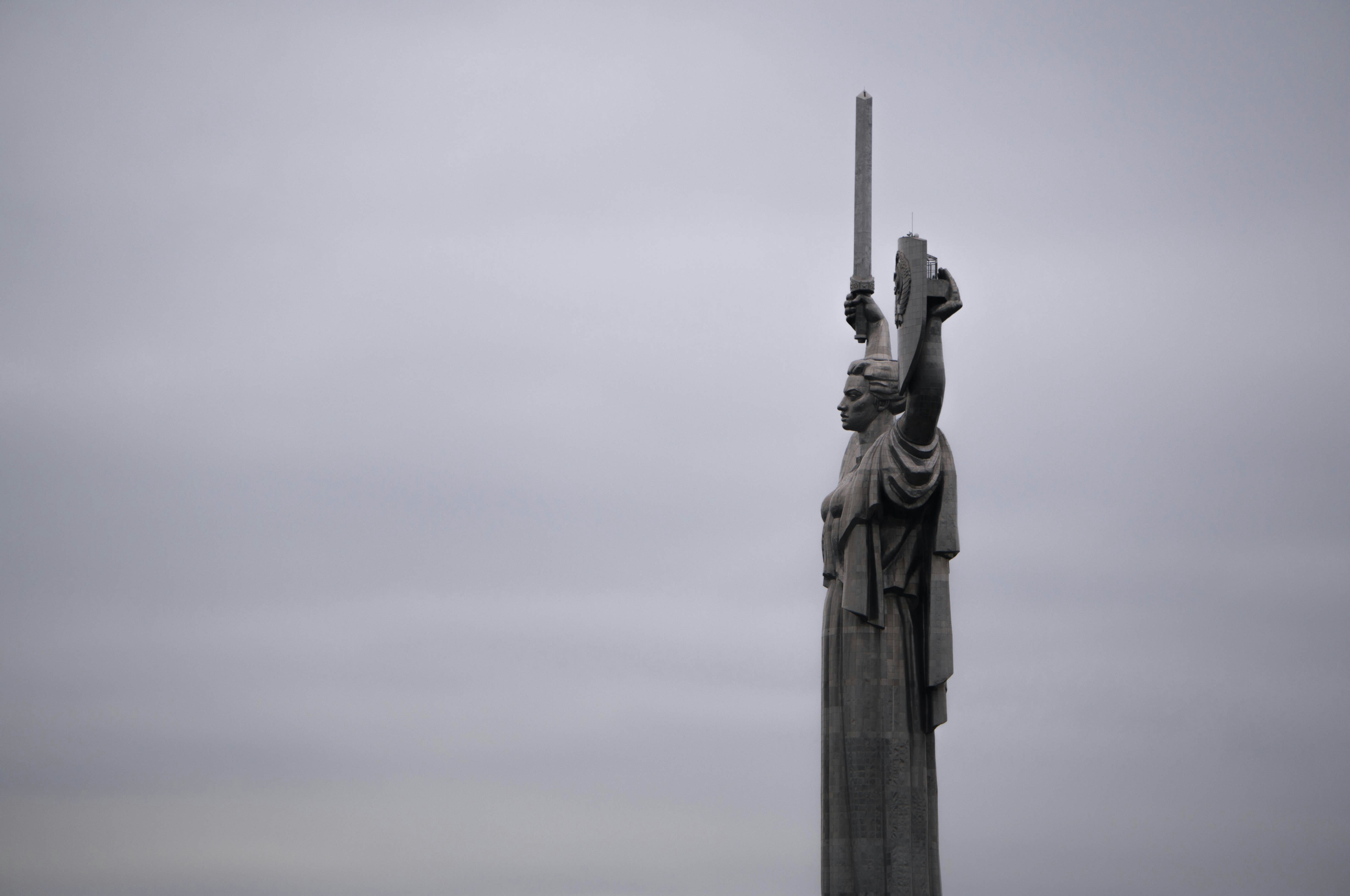 a statue of a person holding a cross