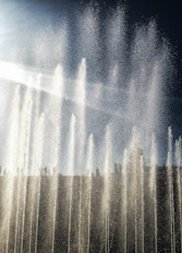 a group of water fountains spewing water into the air