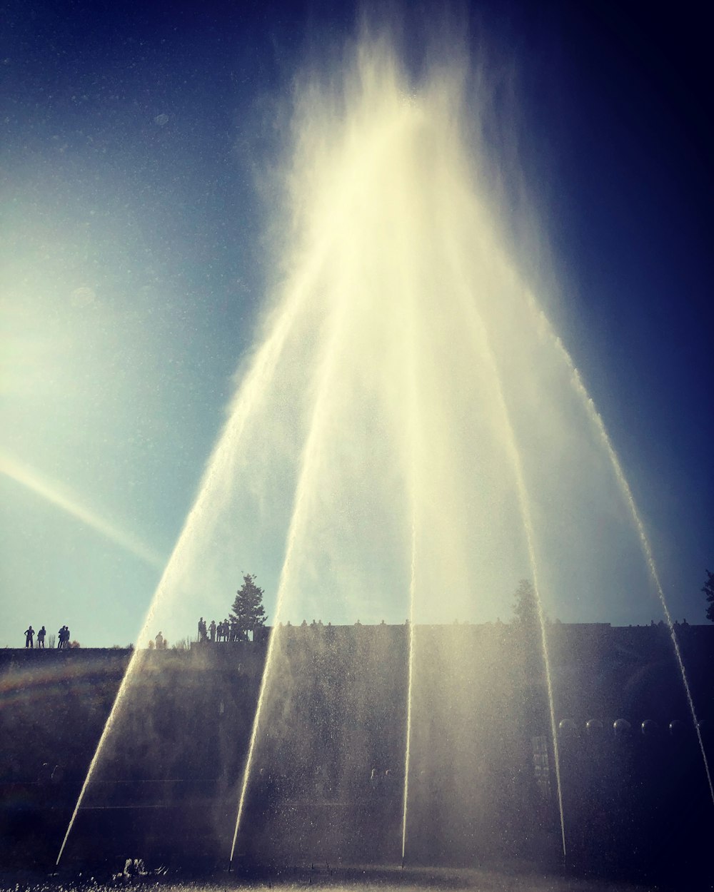 a group of water spewing out of the ground