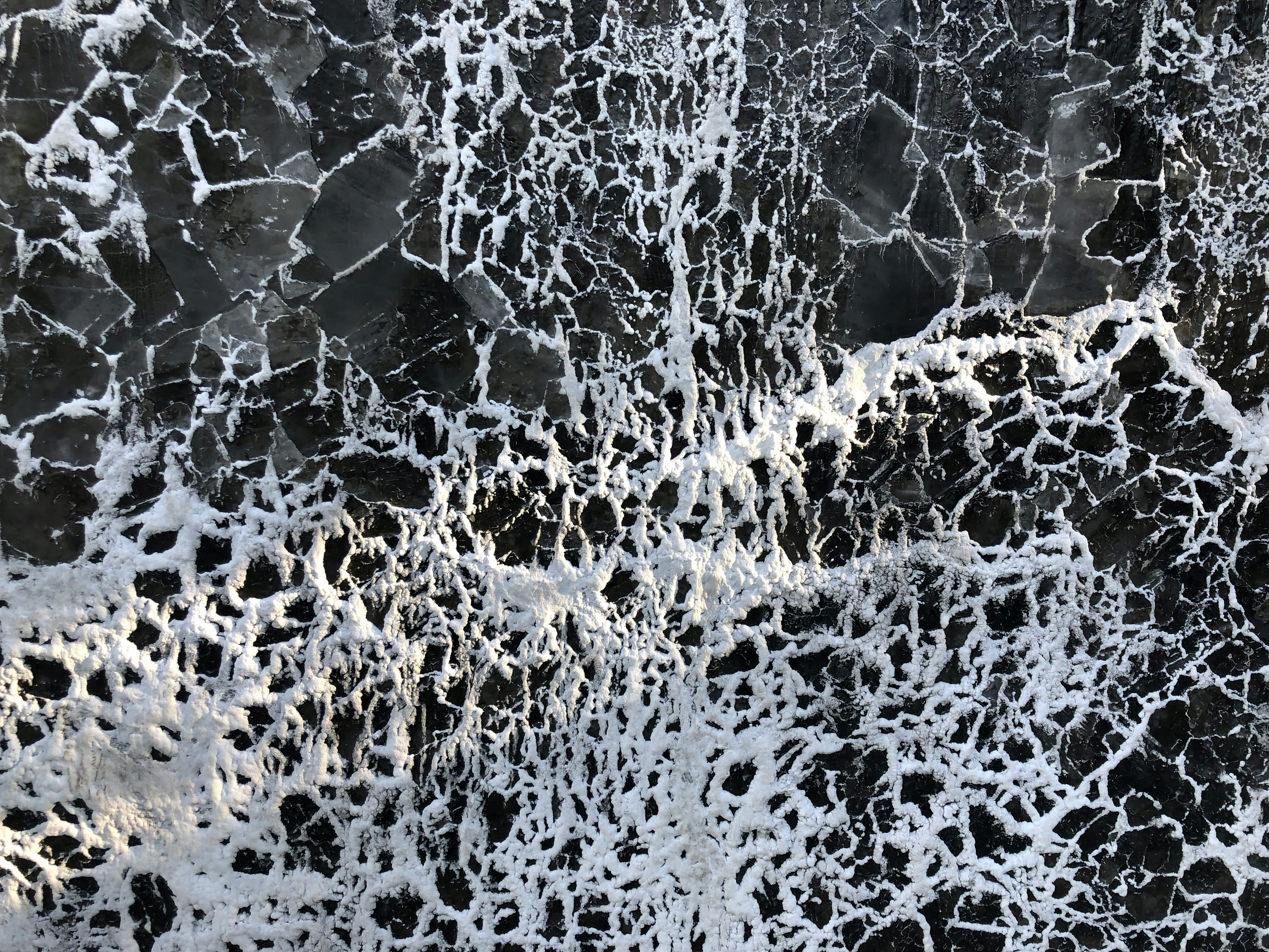 a black and white photo of water and rocks