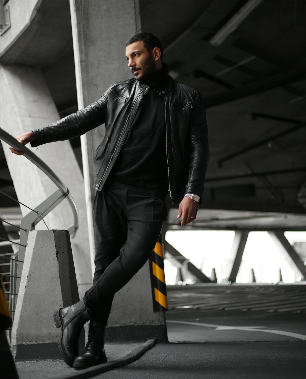 a man in a black jacket and black pants