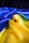 A vibrant, flowing fabric in vivid blue and yellow hues. The fabric appears smooth and shiny, creating a dynamic contrast between the colors. The texture of the material is soft, and the way it is arranged suggests movement and fluidity.