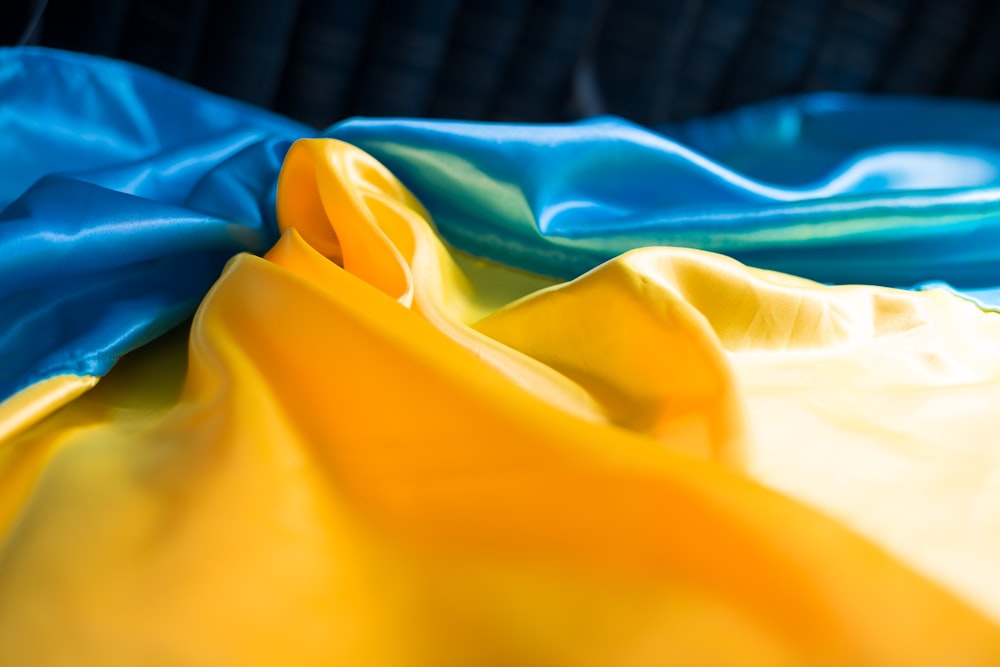 a blue and yellow cloth laying on top of a bed