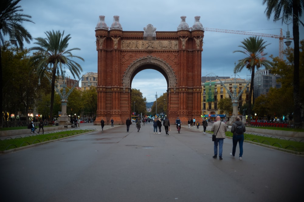 a group of people standing in front of a tall gate