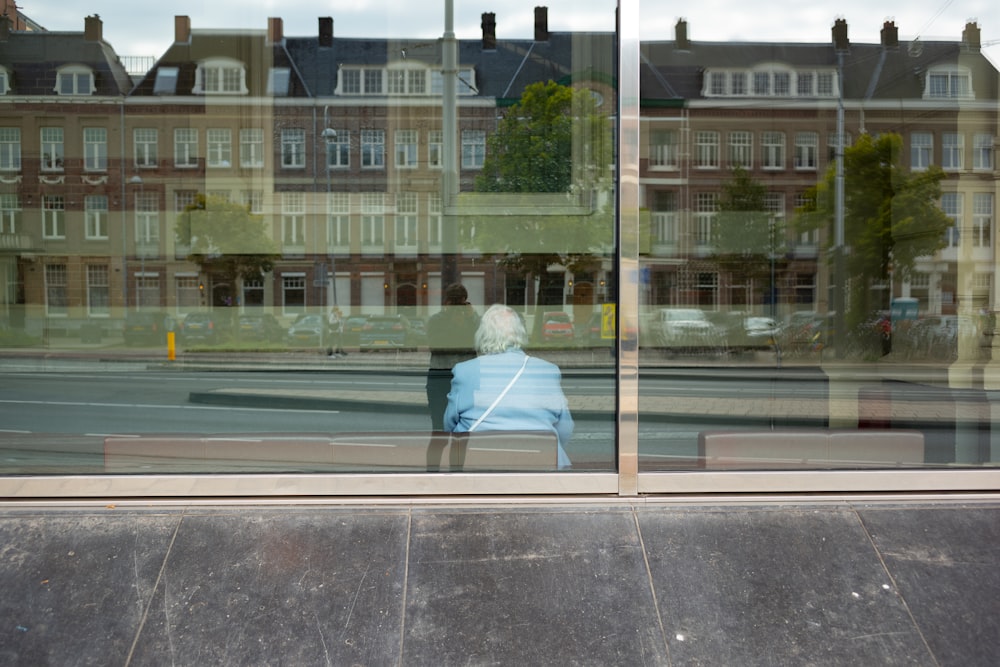 a person sitting in a chair in front of a window