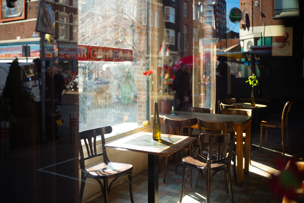 a table and chairs in front of a window