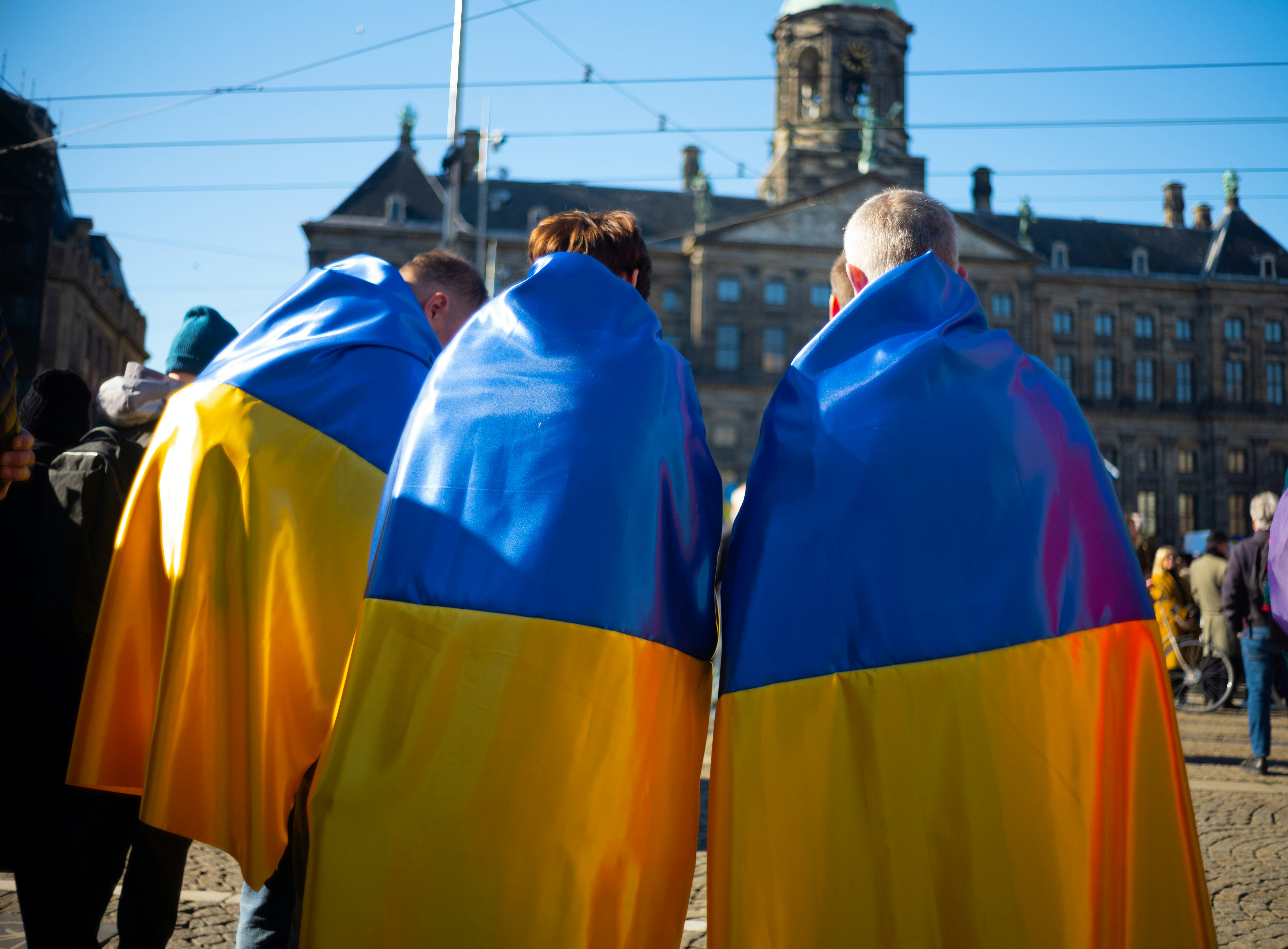 a group of people standing next to each other in front of a building