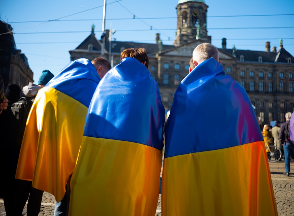 a group of people standing next to each other in front of a building