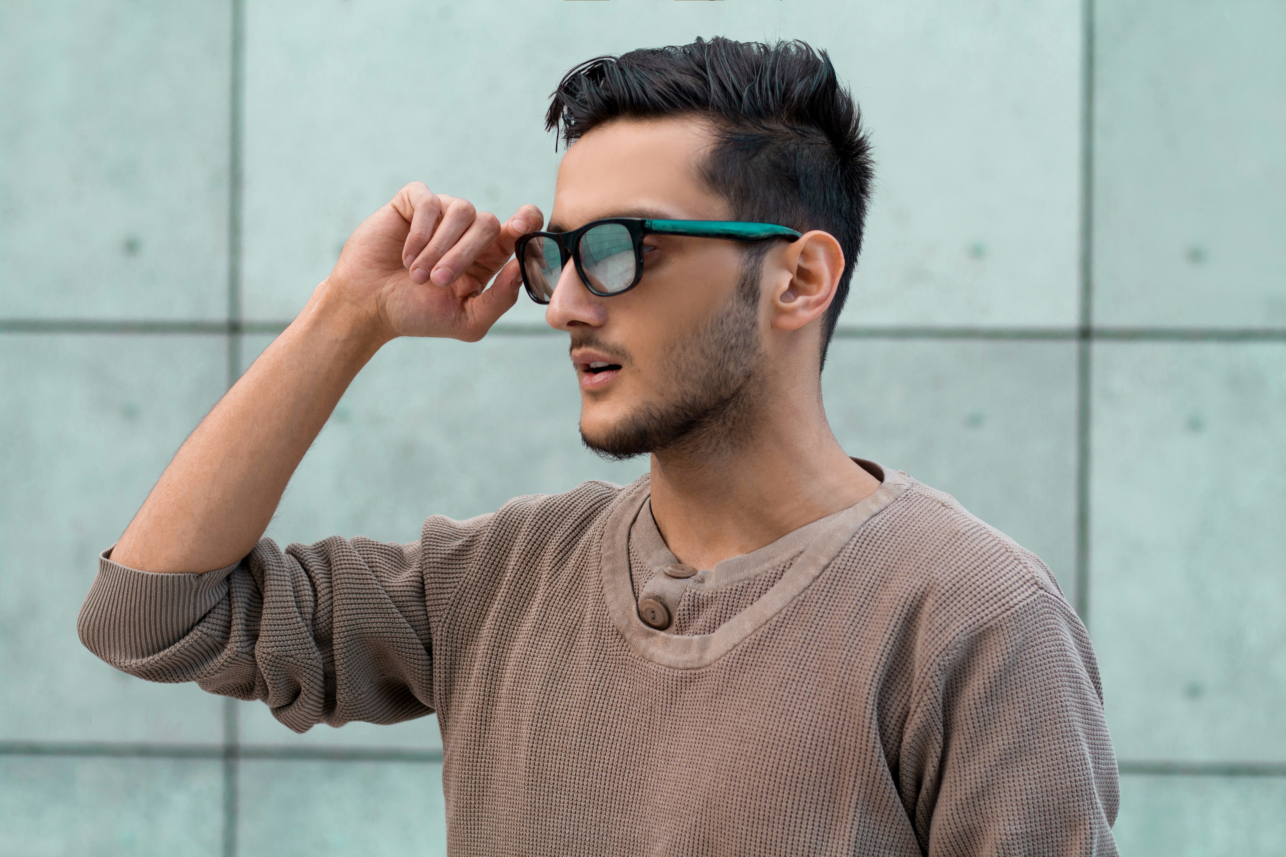 smart glasses sunglasses wearable technology closeup - a man wearing sunglasses and a brown shirt