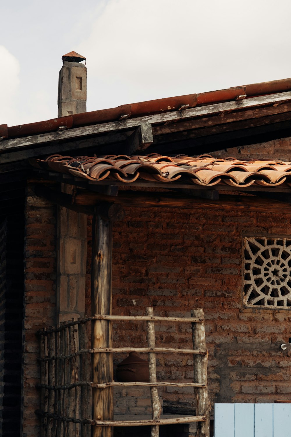 a brick building with a weather vane on the roof