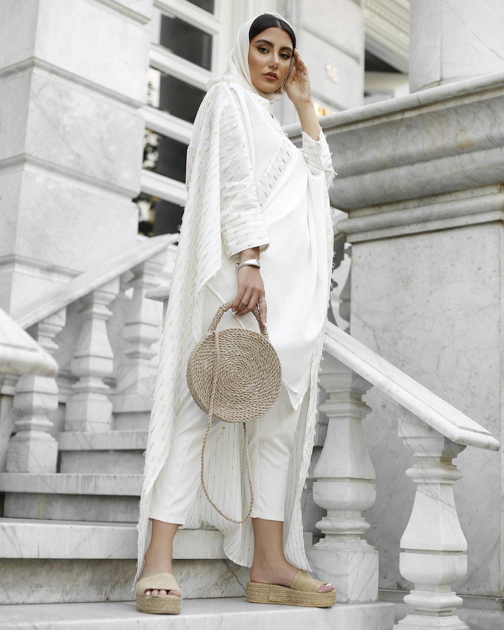 a woman standing on the steps of a building