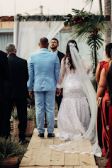 a bride and groom walking down the aisle