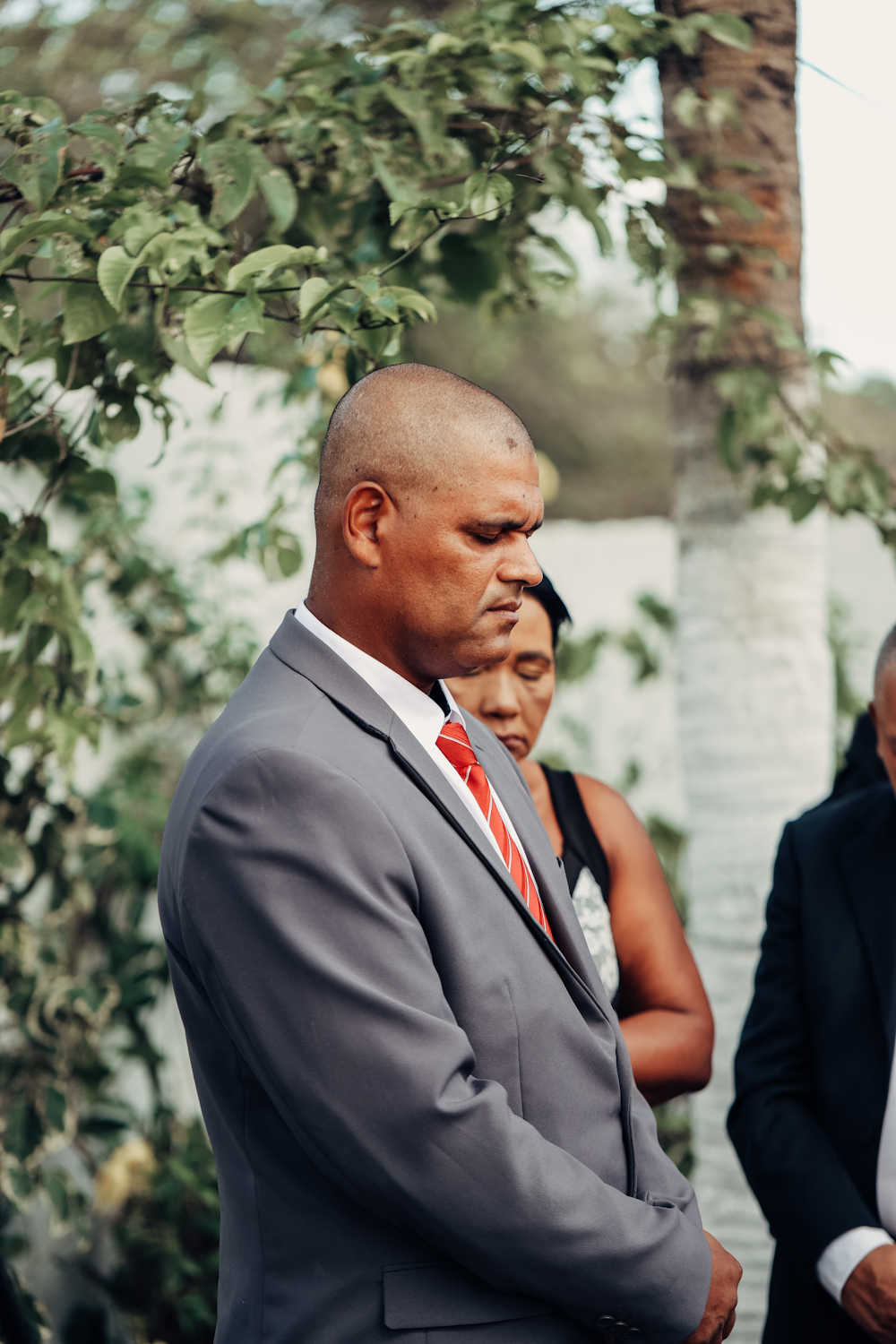 a man in a suit and tie standing next to another man