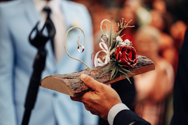 a close up of a person holding a piece of wood