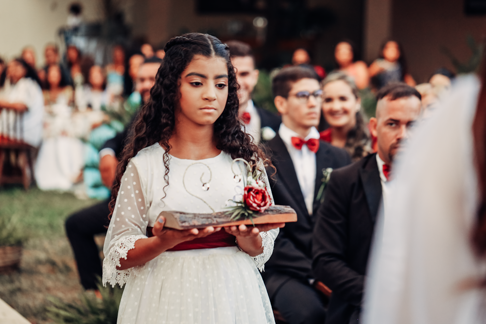 a young girl in a white dress holding a box