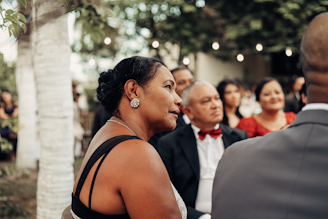 a woman standing next to a man in a tuxedo