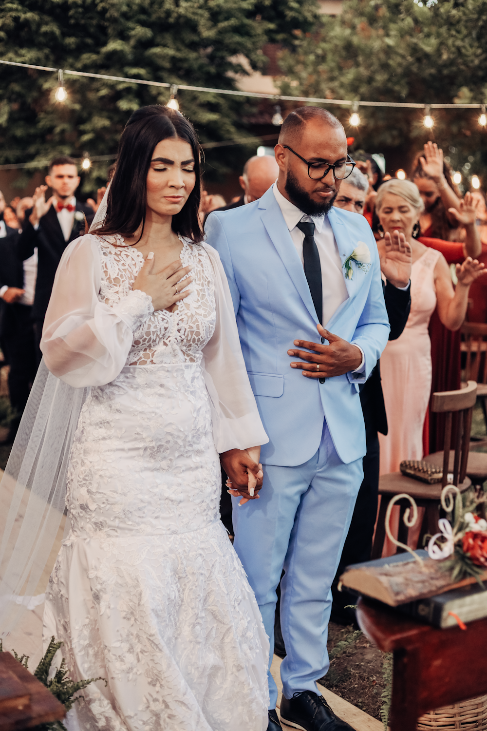 a bride and groom walking down the aisle