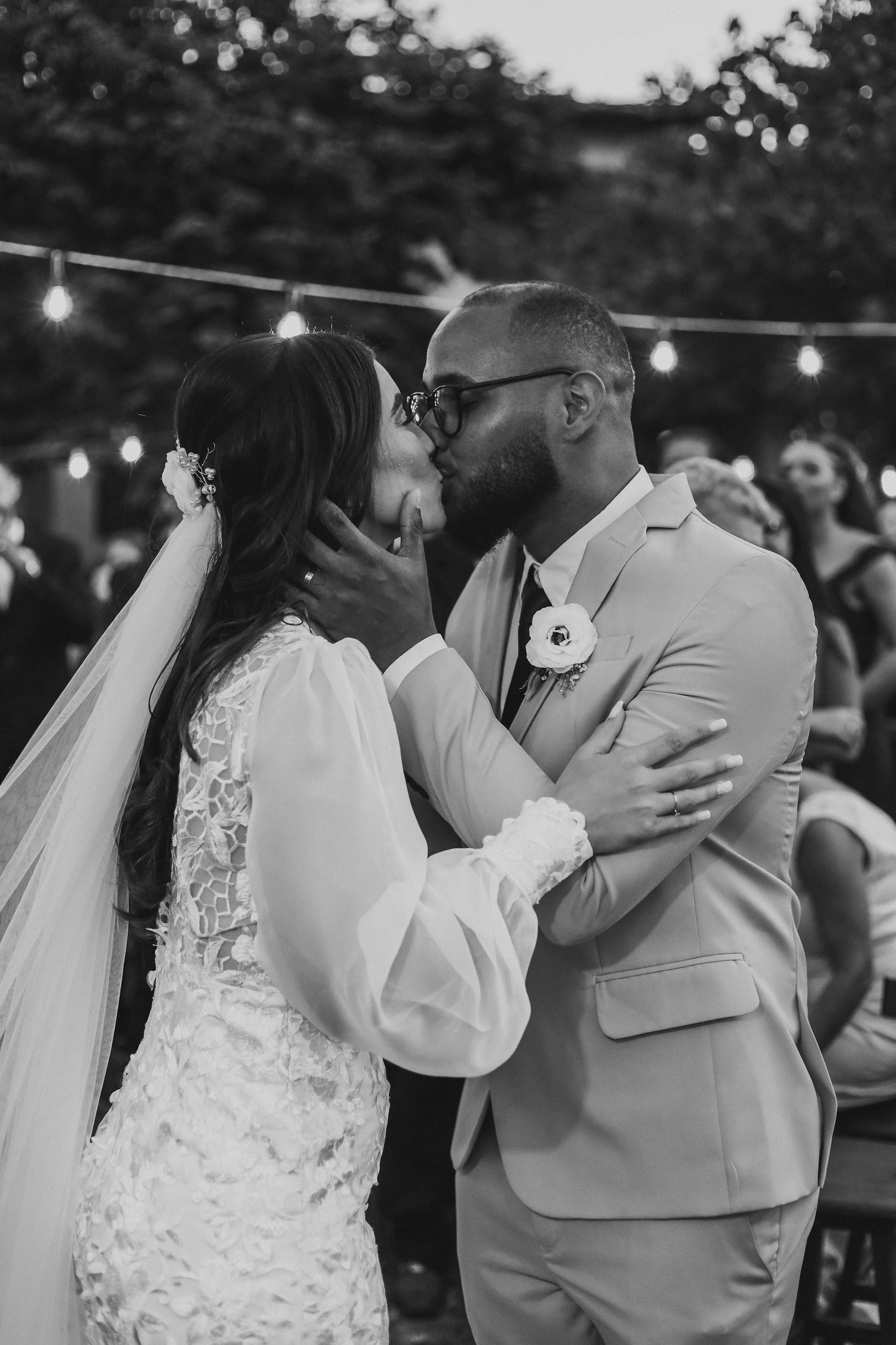a bride and groom kissing in front of a crowd
