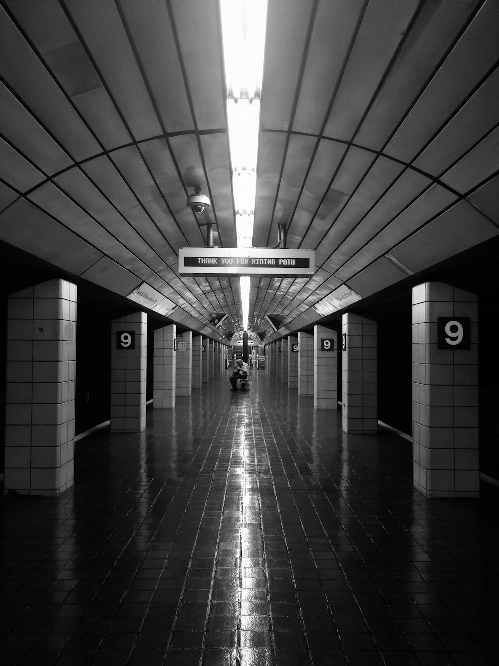 a black and white photo of a subway station