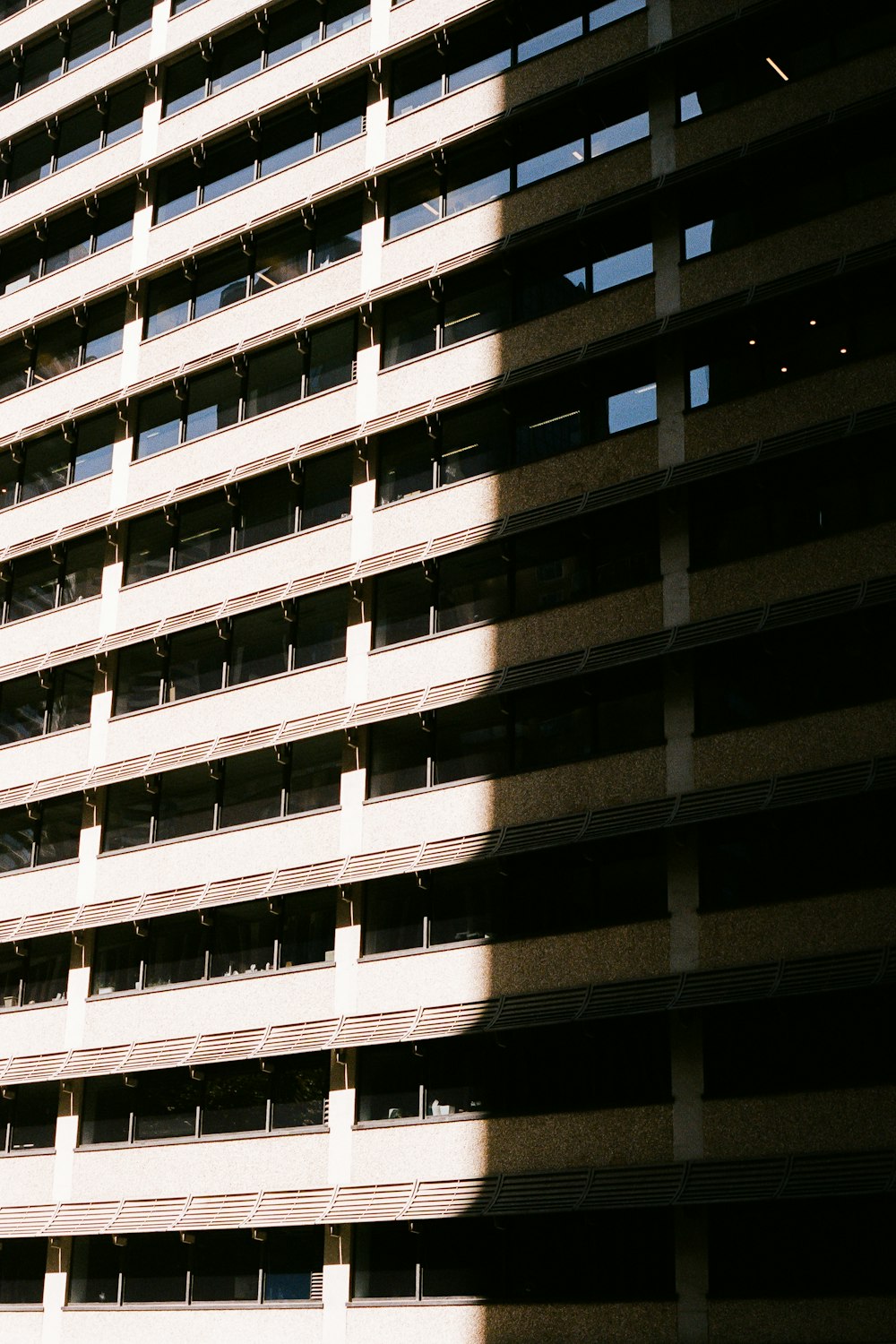 a tall building with lots of windows next to a street