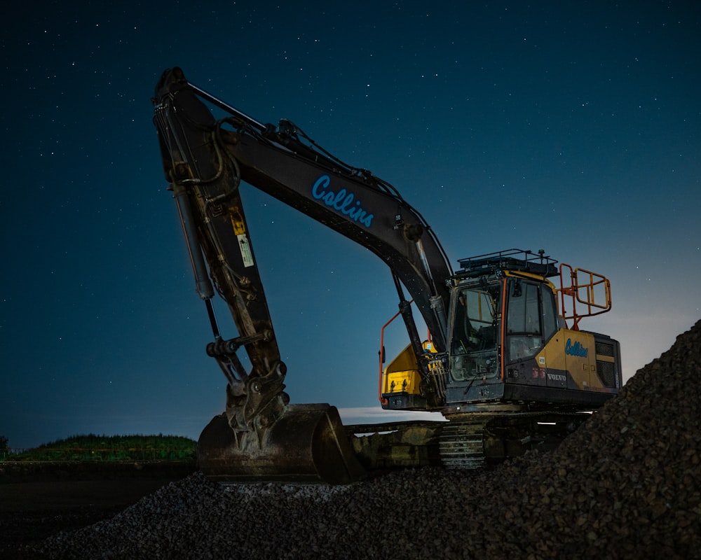 a large excavator sitting on top of a pile of dirt