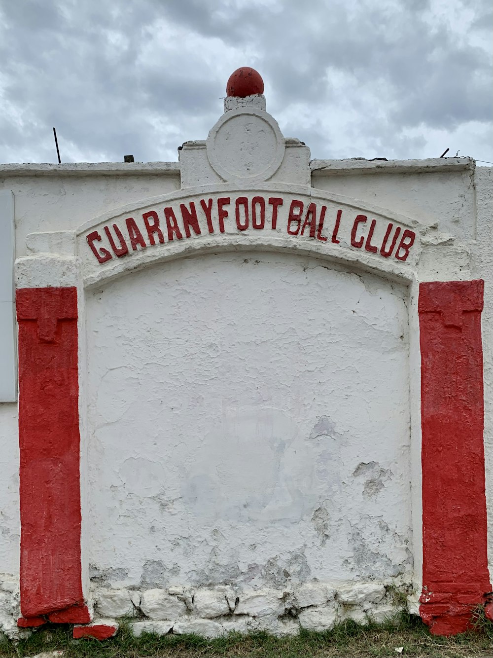 a red and white building with a red and white sign
