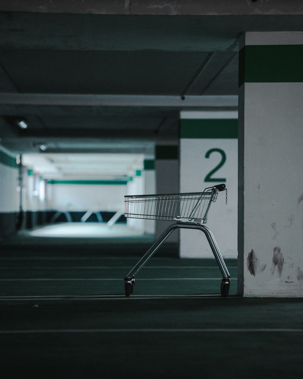 a shopping cart sitting in a parking garage