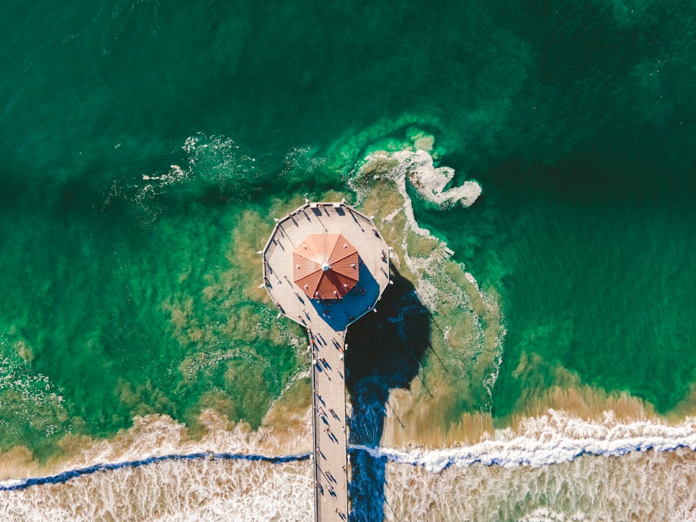 an aerial view of a beach with an umbrella