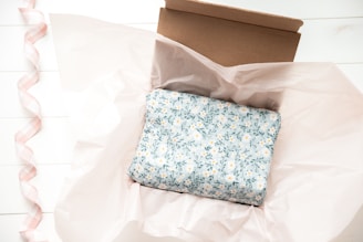 a box with a blue and white flowered cloth inside of it