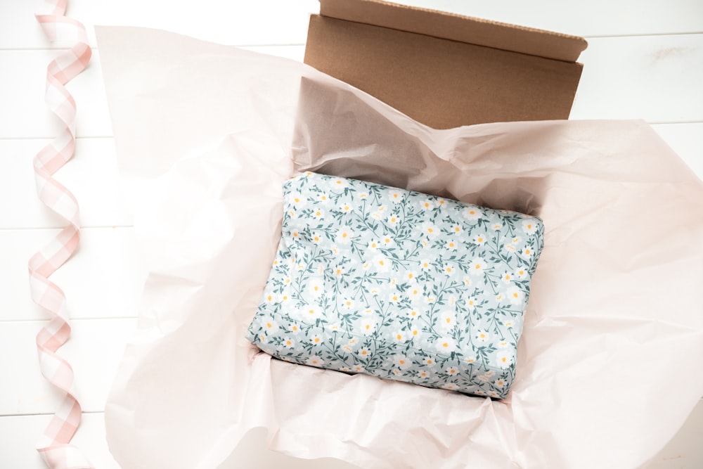 a box with a blue and white flowered cloth inside of it